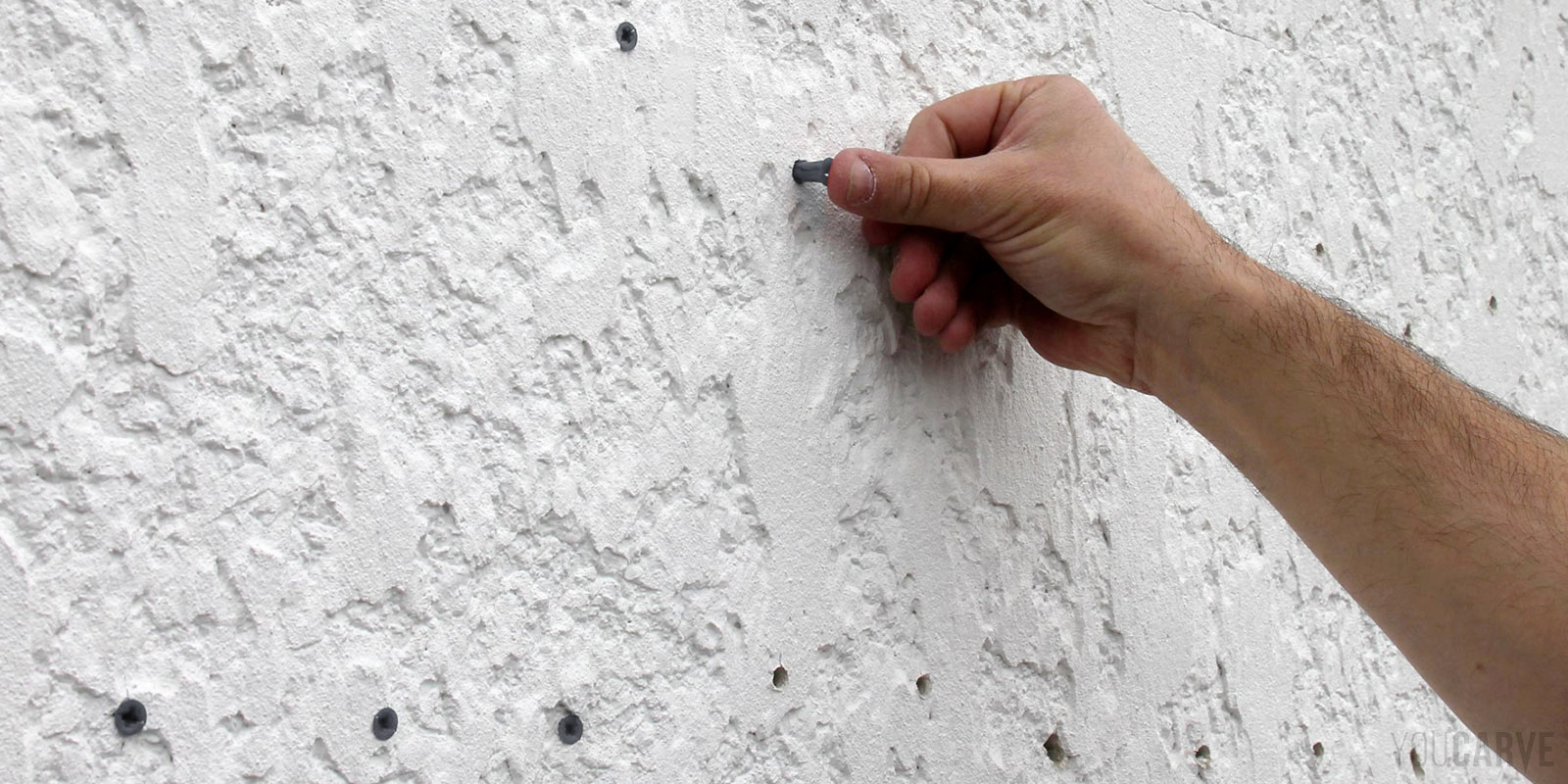 Installation enseigne - Etape 2b - Chevillage Insertion des chevilles dans les trous au mur