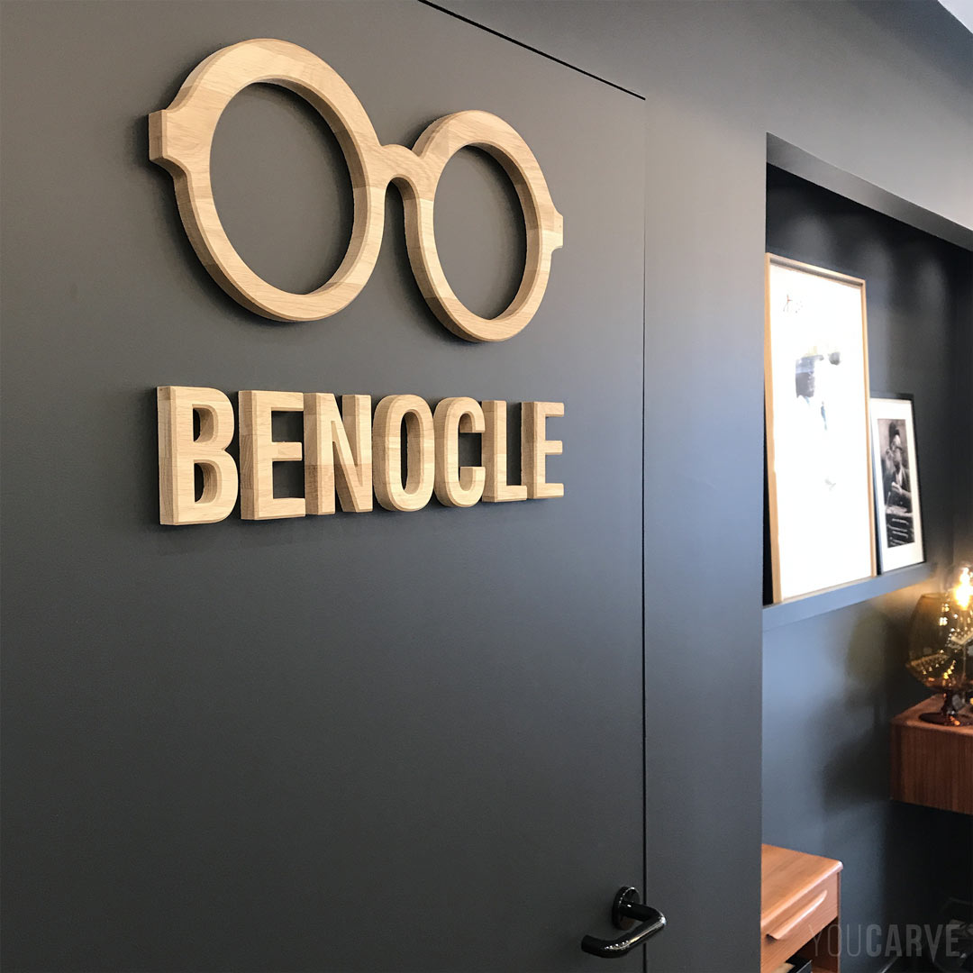 Décoration et logo relief en bois, pictogramme lunettes et lettrage Benocle découpés en bois