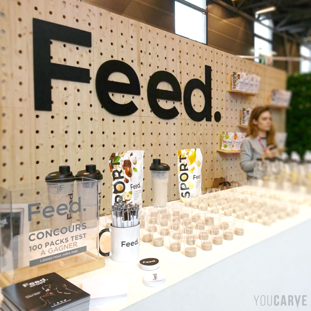 Réalisé par Feed. (nutrition et produits alimentaires) : logo mural en relief pour stand sur salon, découpe sur-mesure en PVC expansé noir épaisseur 10 mm.