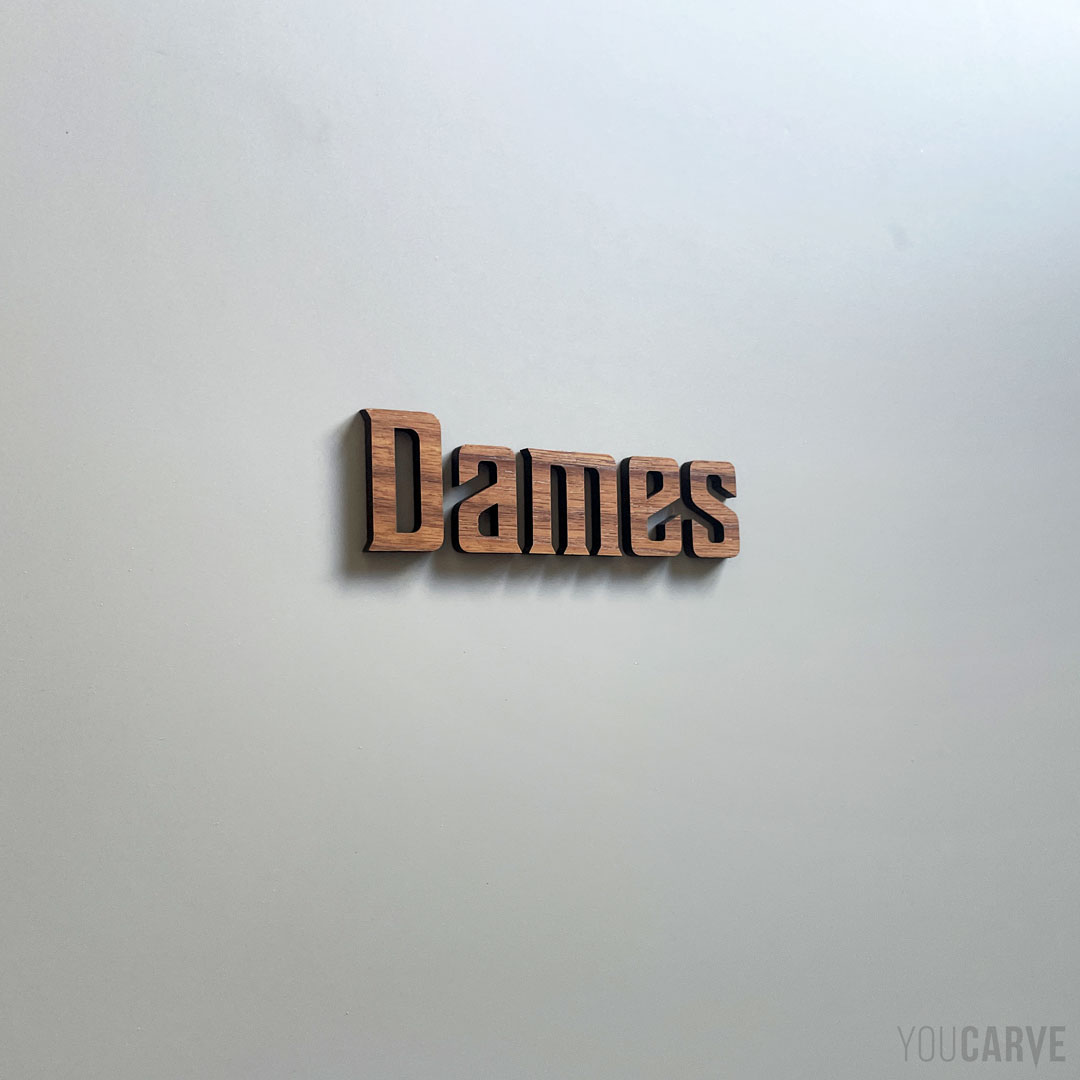 Ladies restroom lettering signage (walnut wood) Ladies letters cut out of walnut wood and glued to a door