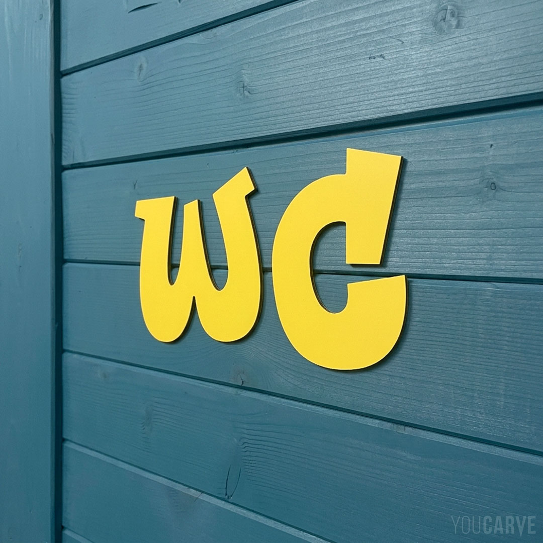WC lettering signage on a restroom door (yellow Alu-Dibond) WC letters cut from yellow alu-dibond glued to a blue wooden door